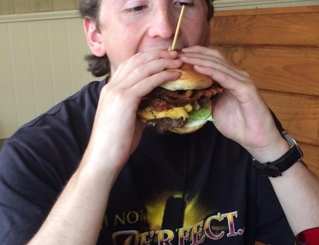 man eating cheeseburger 