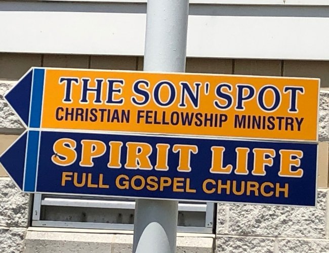 Son Spot Ministries Sign on posted on a pole on the boardwalk